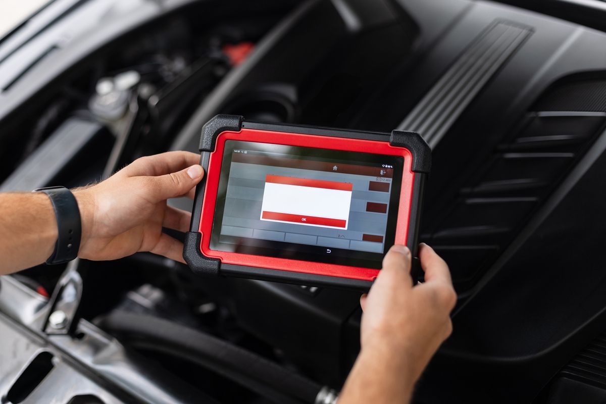 Technician performing OBD-II emissions test